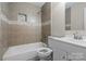 Bathroom features tile flooring, a tub/shower combo, tiled walls, and a modern vanity at 208 Tomberlin Rd, Mount Holly, NC 28120