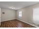 The bedroom features neutral walls, hardwood floors and one window at 208 Tomberlin Rd, Mount Holly, NC 28120