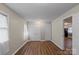 Neutral bedroom showing hardwood flooring, neutral paint, and closet storage at 208 Tomberlin Rd, Mount Holly, NC 28120