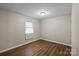 Hardwood floor bedroom with one window and neutral walls at 208 Tomberlin Rd, Mount Holly, NC 28120