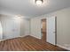 The bedroom features neutral walls, hardwood floors and closet storage at 208 Tomberlin Rd, Mount Holly, NC 28120