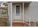 Close up view of front entry featuring painted brick stairs and painted porch railing at 208 Tomberlin Rd, Mount Holly, NC 28120