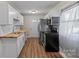 Updated kitchen with stainless appliances, white cabinets, and butcher block counters at 208 Tomberlin Rd, Mount Holly, NC 28120