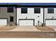 Modern townhome exterior with individual driveways and single-car garages at 209 Halemarg Dr, Belmont, NC 28012