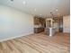 Open-concept kitchen and living area with modern finishes and wood flooring at 209 Halemarg Dr, Belmont, NC 28012