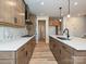 Spacious kitchen featuring wood cabinets, quartz countertops, stainless steel appliances, and modern backsplash at 209 Halemarg Dr, Belmont, NC 28012