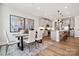 Stylish kitchen with dining area, modern lighting, stainless steel appliances, and hardwood floors at 209 Halemarg Dr, Belmont, NC 28012