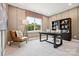 A modern home office features a sleek desk, a comfortable leather chair, and ample natural light at 209 Halemarg Dr, Belmont, NC 28012