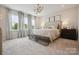 Elegant bedroom with large windows, designer lighting, and plush carpet at 211 Halemarg Dr, Belmont, NC 28012