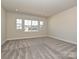 Bright and spacious bedroom with large windows offering lots of natural light and plush carpeting at 211 Halemarg Dr, Belmont, NC 28012
