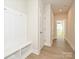 Well-lit hallway with built-in bench and storage, and a view into adjacent rooms at 211 Halemarg Dr, Belmont, NC 28012