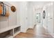 Neutral colored hallway with stylish drop zone bench and coat hooks at 211 Halemarg Dr, Belmont, NC 28012