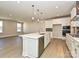 Bright kitchen featuring a large quartz island, stainless steel appliances, and hardwood floors at 211 Halemarg Dr, Belmont, NC 28012
