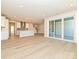 Open-concept living room with hardwood floors and a modern kitchen featuring stainless steel appliances and pendant lighting at 211 Halemarg Dr, Belmont, NC 28012