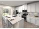 Modern kitchen boasts white cabinets, stainless steel appliances, granite countertops, and a kitchen island with seating at 213 Alden Ct, Shelby, NC 28152