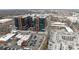 Aerial view showcasing modern brick and glass buildings next to a parking lot and patio at 225 Lincoln St, Charlotte, NC 28203