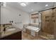 Bathroom with granite countertop vanity, soaking tub, and glass-enclosed shower at 225 Lincoln St, Charlotte, NC 28203