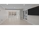 Bonus room with tile floors, French doors, recessed lights, and a wall-mounted television at 225 Lincoln St, Charlotte, NC 28203
