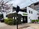 A modern building with patio and outdoor seating, plants, and signage at 225 Lincoln St, Charlotte, NC 28203