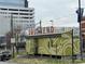 View of green building with Souther End mural with trees and other buildings at 225 Lincoln St, Charlotte, NC 28203