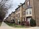 A row of beautiful brown brick townhomes offers timeless appeal and neighborhood charm at 225 Lincoln St, Charlotte, NC 28203