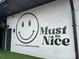 A whimsical mural reads 'Must be Nice' creating a friendly neighborhood vibe at 225 Lincoln St, Charlotte, NC 28203