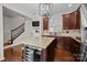 Kitchen featuring dark wood cabinets, granite countertops, stainless steel appliances and a wine refrigerator at 225 Lincoln St, Charlotte, NC 28203