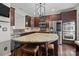Kitchen featuring dark cabinets, granite countertops, stainless steel appliances, and a large island at 225 Lincoln St, Charlotte, NC 28203