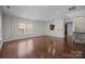 Large living room with hardwood floors and lots of natural light, open to kitchen and stairs at 225 Lincoln St, Charlotte, NC 28203