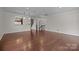 Large living room with gleaming hardwood floors and stairs leading to the upper level at 225 Lincoln St, Charlotte, NC 28203