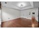 Spacious main bedroom with hardwood floors, tray ceiling, and double-door closet at 225 Lincoln St, Charlotte, NC 28203