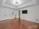 Main bedroom featuring hardwood floors, recessed lights, and a mounted TV at 225 Lincoln St, Charlotte, NC 28203