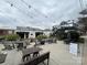 Outdoor seating with tables, chairs, and string lights for a welcoming ambiance at 225 Lincoln St, Charlotte, NC 28203