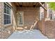 View of concrete patio with brick wall, exterior door, and a window at 225 Lincoln St, Charlotte, NC 28203