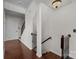 Staircase with wrought iron railings and wood floors at 225 Lincoln St, Charlotte, NC 28203