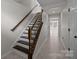 Classic staircase with dark wood accents and tile flooring leading to a bright living area at 225 Lincoln St, Charlotte, NC 28203