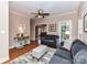 Comfortable living room with hardwood floors, a ceiling fan and a seamless view into the dining area at 2553 Willowbrook Dr, Matthews, NC 28104