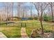 Fenced backyard featuring a lush lawn, storage building, and a carport providing ample space for outdoor activities at 406 Forest Dr, York, SC 29745