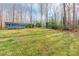 Expansive backyard showcasing a storage building, mature trees, and a well-maintained lawn for outdoor enjoyment at 406 Forest Dr, York, SC 29745