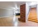 Open basement area with brick feature and adjacent stairs to upper floors at 406 Forest Dr, York, SC 29745