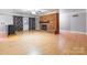 Basement with brick fireplace, door to outside, and wood-look flooring at 406 Forest Dr, York, SC 29745
