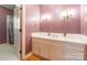 This bathroom features a single sink vanity, decorative wall sconces and a door to shower at 406 Forest Dr, York, SC 29745