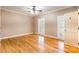 Bedroom featuring hardwood floors, neutral walls, white trim, plantation shutters, and an open door at 406 Forest Dr, York, SC 29745