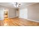 Large bedroom featuring hardwood floors, neutral walls, white trim, and access to the bath and closet at 406 Forest Dr, York, SC 29745