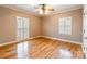 Spacious bedroom featuring hardwood floors, neutral walls, bright windows, and a ceiling fan at 406 Forest Dr, York, SC 29745