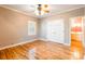Neutral bedroom boasts hardwood floors, a ceiling fan, and closet with an adjacent bathroom at 406 Forest Dr, York, SC 29745