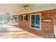 Inviting covered patio featuring brick flooring, ceiling fans, and access to the home through sliding glass doors at 406 Forest Dr, York, SC 29745