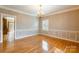 Formal dining room features hardwood floors, wainscoting, and a stylish chandelier at 406 Forest Dr, York, SC 29745