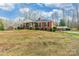 Classic brick home featuring a wide porch with stately columns and a well-manicured lawn at 406 Forest Dr, York, SC 29745