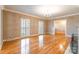 Spacious living room with plantation shutters, fireplace, and pristine hardwood floors at 406 Forest Dr, York, SC 29745